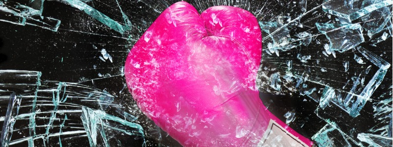 pink boxing glove shattering glass